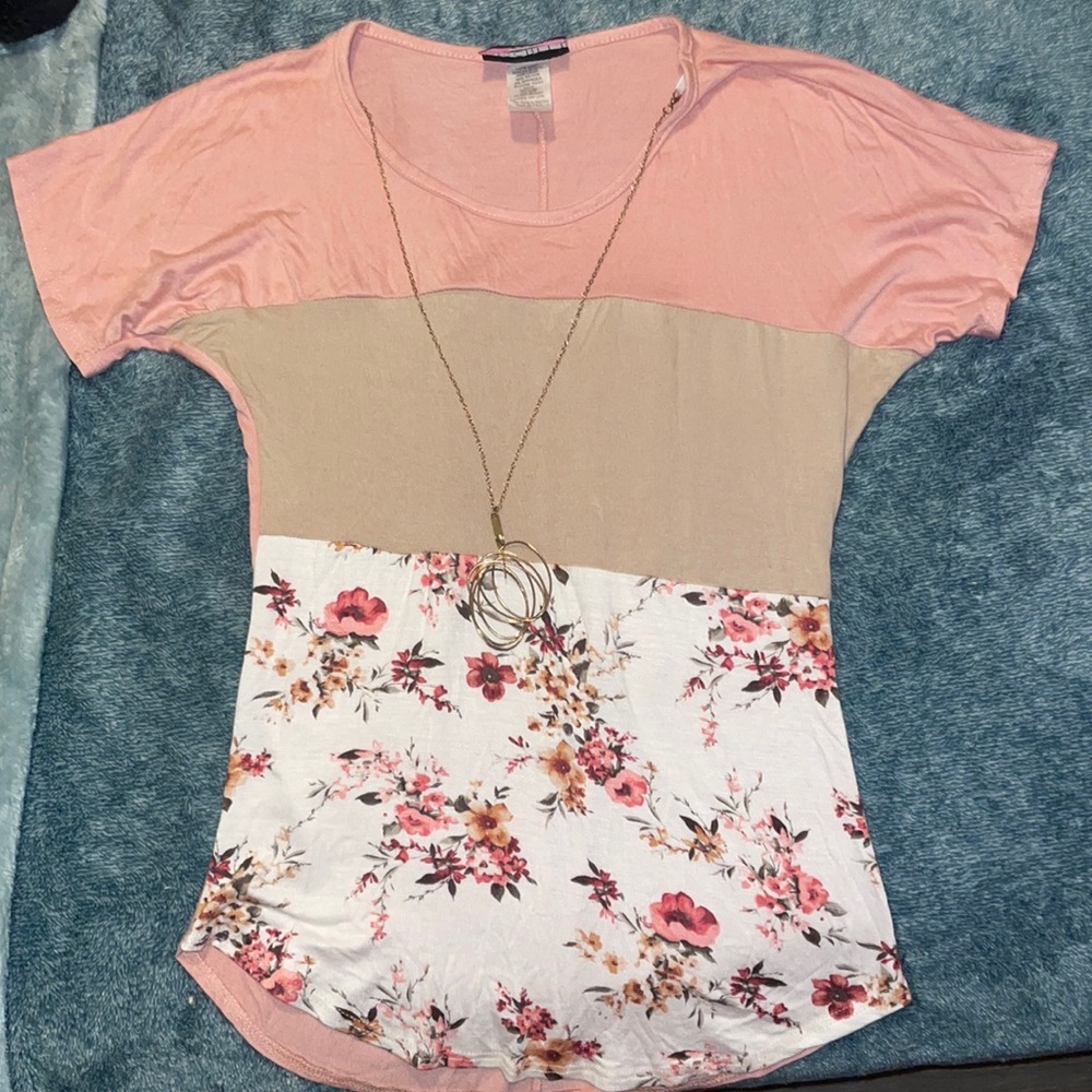it’s pick with a brown tan color with white and with flowers, it’s really soft